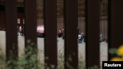 FILE - Migrants camp between the two border fences as they wait for authorities to request asylum in San Ysidro, California, as seen from Tijuana, Mexico, April 24, 2023.
