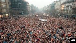 FILE - In this Nov. 21, 1989, file photo about 200,000 people gather in Wenceslas Square, Prague, Czechoslovakia. Dubbed the 'Velvet Revolution' for its non-violent nature, the protests led to the resignation of the Communist Party's leadership.