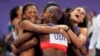 The United States' women 4x400-meter relay team celebrates winning the gold medal, Aug. 10, 2024, in Saint-Denis, France.