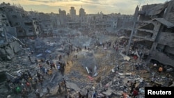 Palestinians search for casualties at the site of Israeli strikes on houses in Jabalia refugee camp in the northern Gaza Strip, Oct. 31, 2023.