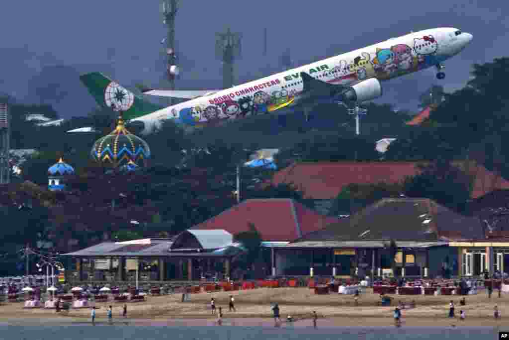 An EVA Air Airbus A330 with a special livery showing Sanrio characters including Hello Kitty takes off from I Gusti Ngurah Rai International Airport near Denpasar on the island of Bali in Indonesia.