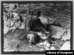 A Navajo silversmith at work, from the "Navajo series," copyrighted 1915 by Pennington & Rowland.