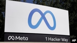 FILE - Facebook's Meta logo sign is seen at the company headquarters in Menlo Park, Calif., Oct. 28, 2021. European Union hits Facebook parent Meta with record $1.3 billion fine over transfers of user data to US. 