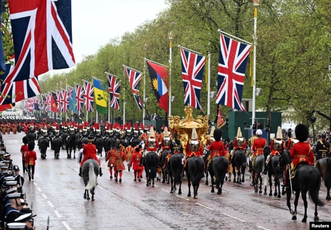 On Coronation Day, King Charles III and Queen Camilla ride in a gold state coach — built in 1762 and used in every coronation since 1831 — in London, May 6, 2023.