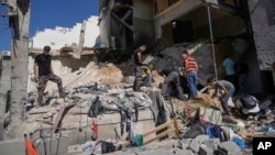Palestinians inspect the destruction following an Israeli operation in Nur Shams refugee camp, near the West Bank town of Tulkarem, June 30, 2024. 