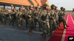 Chinese military personnel head to a field to participate in the Golden Dragon military exercises in Svay Chok village, Kampong Chhnang province, north of Phnom Penh, Cambodia, May 16, 2024.