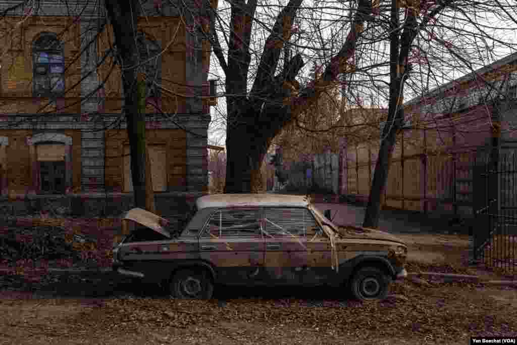 A semi-destroyed car is abandoned in one of the many empty streets of Kostyantynivka, a strategic city in the heart of Donbas that has been relentlessly targeted by Russian forces, on March 2, 2024. 