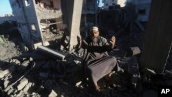 A Palestinian reacts after an Israeli strike on residential buildings in Rafah, Gaza Strip, on Dec. 15, 2023.