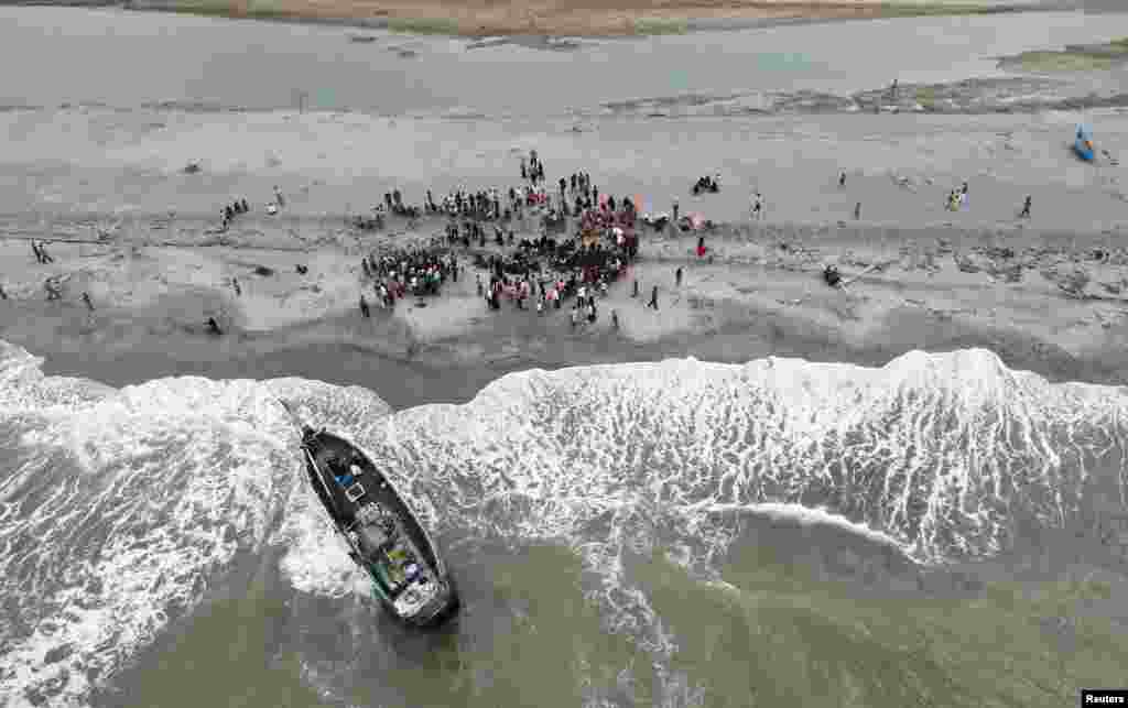 A boat carrying Rohingya Muslims is seen stranded at Lampanah beach, in Aceh province, Indonesia.