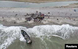 A boat carrying Rohingya Muslims lies stranded at Lampanah beach, in Aceh province, Indonesia, on Feb. 16, 2023.