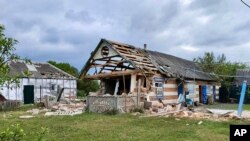 This handout photo released by Belgorod region Governor Vyacheslav Gladkov's Telegram channel, May 23, 2023, shows damaged houses in Russia's western Belgorod region.