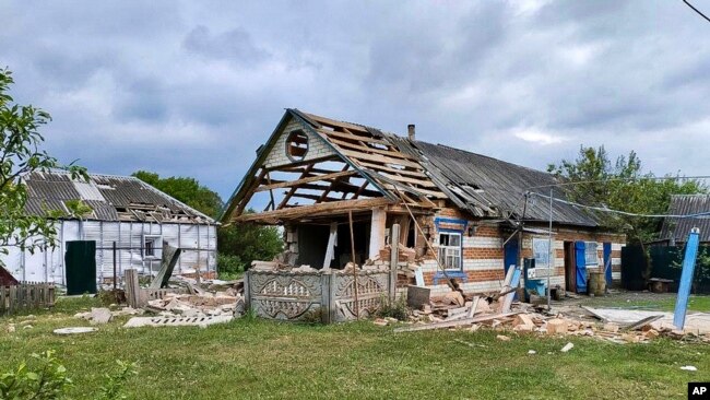 This handout photo released by Belgorod region Governor Vyacheslav Gladkov's Telegram channel, May 23, 2023, shows damaged houses in Russia's western Belgorod region.