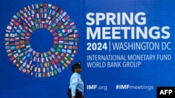 A security guard walks past the International Monetary Fund (IMF) headquarters on April 12, 2024, in Washington, DC, ahead of the IMF/World Bank 2024 Spring Meetings. 
