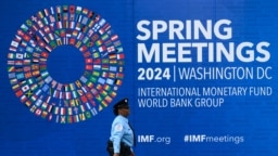 A security guard walks past the International Monetary Fund (IMF) headquarters on April 12, 2024, in Washington, DC, ahead of the IMF/World Bank 2024 Spring Meetings. 
