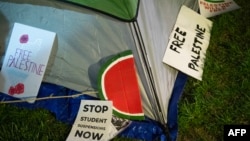 FILE - Signs lie next to a tent pro-Palestinian students and faculty of Drexel University, Temple University and the University of Pennsylvania erected at an encampment at the University of Pennsylvania campus in Philadelphia, April 25, 2024.