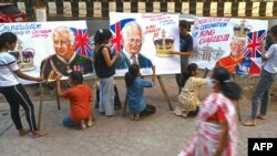 Art school students give final touches to paintings depicting Britain's King Charles III ahead of his coronation, in Mumbai, India.