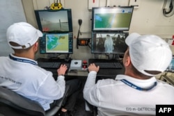 Controllers man a terminal at the command station of the Israel Aerospace Industries (IAI) in an unmanned maritime demonstration during the Naval Defense and Maritime Security Exhibition (NAVDEX), part of the wider International Defense Exhibition (IDEX) at the Abu Dhabi International Exhibition Centre, Feb. 20, 2023.
