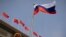 FILE - The Russian flag flutters at the Great Hall of the People in Beijing, May 24, 2023. The U.S. has added more Chinese companies to its Entity List for reportedly helping firms affiliated with the Russian military obtain U.S.-made goods that cannot legally be sold to them. 