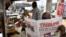 A vendor reads a paper at a newsstand at Ikeja district of Lagos, Feb. 27, 2023 while the country awaits results for the presidential elections. 