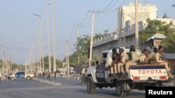 Somali security forces arrive to secure the street near the scene of a militant attack at a building in Abdias district of Mogadishu, Somalia Feb. 21, 2023.