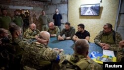 Ukrainian President Volodymyr Zelenskyy attends a meeting with commanders of Ukrainian Armed Forces brigades as he visits a frontline in Donetsk region, Sept. 4, 2023.