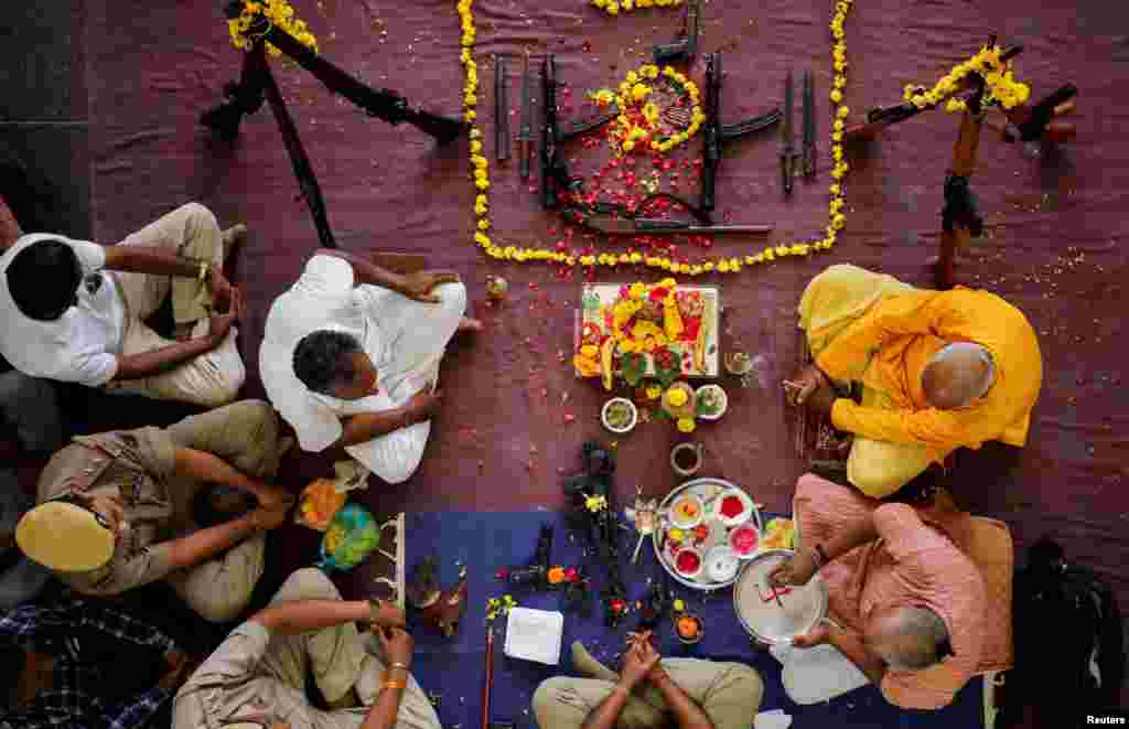 Police officers offer prayers to their weapons as part of a ritual at their headquarters on the occasion of Dussehra, or Vijaya Dashami festival in Ahmedabad, India.