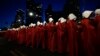 Israeli women's rights activists dressed as characters in the television series 'The Handmaid's Tale' protest plans by Prime Minister Benjamin Netanyahu's government to overhaul the judicial system, in Tel Aviv, Israel, March 11, 2023.