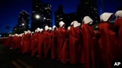 Israeli women's rights activists dressed as characters in the television series 'The Handmaid's Tale' protest plans by Prime Minister Benjamin Netanyahu's government to overhaul the judicial system, in Tel Aviv, Israel, March 11, 2023.