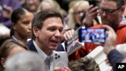 FILE - Florida Gov. Ron DeSantis greets people in the crowd during an event March 10, 2023, in Davenport, Iowa. 