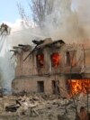 In this handout photo made available by the State Emergency Service of Ukraine, firefighters hose down a Policlinic on fire following a Russian attack in Dnipro, Ukraine, May 26, 2023.