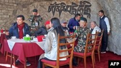 United Nations Secretary-General Antonio Guterres (2R) sits to have tea during his visit at the Syangboche in the Everest region of Solukhumbu district on Oct. 30, 2023. (Photo by Tshering Sherpa / AFP)