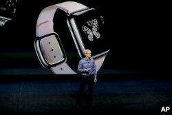 File - Apple CEO Tim Cook discusses the Apple Watch at the Apple event at the Bill Graham Civic Auditorium in San Francisco, Sept. 9, 2015.