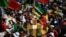 Pilgrims hold a cross-shaped sign as they wait for the start of the opening mass of the World Youth Day (WYD) gathering of young Catholics in Eduardo VII Park in Lisbon on Aug. 1, 2023. 