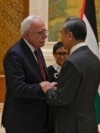 FILE - Chinese Foreign Minister Wang Yi, right, shakes hands with Palestine Foreign Minister Riyad al-Maliki as he meets with his five Arab and Islamic counterparts at the Diaoyutai state guesthouse in Beijing, Nov. 20, 2023. 