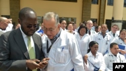FILE - Kisumu Governor Professor Anyang Nyongo, left, talks with one of the 100 doctors from Cuba attending a program at the Kenya School of Government in Nairobi, June 11, 2018. Chinese literature is now being displayed to the public in the institution. 