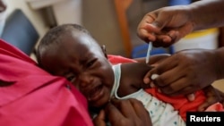 FILE - A nurse administers the malaria vaccine to an infant at the Lumumba Sub-County hospital in Kisumu, Kenya, July 1, 2022. (REUTERS/Baz Ratner)