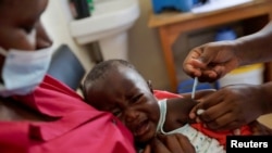 FILE - A nurse administers a malaria vaccine to an infant at the Lumumba Sub-County hospital in Kisumu, Kenya, July 1, 2022. 