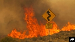 Flames rise from the York Fire in the Mojave National Preserve, California, July 30, 2023.