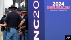 Indiana State Police stand outside the Fiserv Forum during preparations for the Republican National Convention, July 14, 2024, in Milwaukee, Wisconsin.