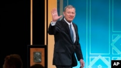 FILE - U.S. Supreme Court Chief Justice John Roberts waves after receiving the Henry J. Friendly Medal during the American Law Institute's annual dinner in Washington, May 23, 2023.