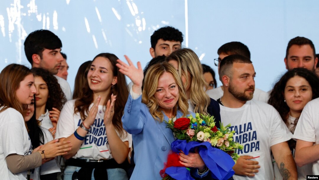 Italy's Prime Minister Giorgia Meloni gestures, as she holds a bouquet of flowers, during a "Brothers of Italy" (Fratelli d'Italia) right-wing party conference in Pescara, April 28, 2024. 