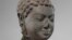 This December 2005 photo shows a 7th century sculpture titled "Head of Buddha" at the Metropolitan Museum of Art in New York. The sculpture is one of 16 pieces of artwork that the museum said it will return to Cambodia and Thailand. (Metropolitan Museum of Art via AP)