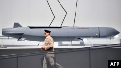 FILE - A member of the military walks past a MBDA Storm Shadow/Scalp missile at the Farnborough Airshow, south west of London, on July 17, 2018