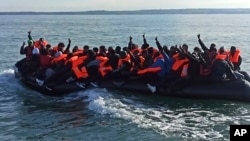 This photo provided by the Prefecture Maritime du Nord et de la Manche shows migrants continuing their journey to Britain off the northern coast of France, April 23, 2024. 