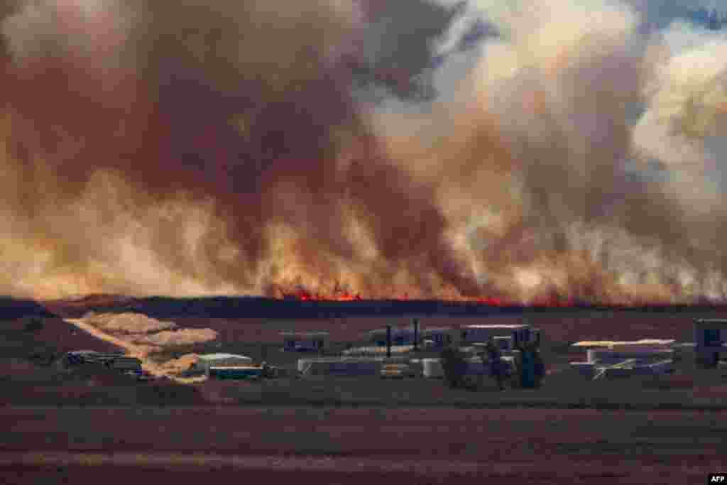 Fire sweep over the Marjayoun plain in southern Lebanon near the border with Israel after being hit by Israeli shelling.