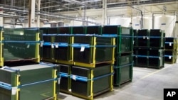 Stacks of panes are shown during a tour of the Fuyao Glass America plant, Oct. 7, 2016, in Moraine, Ohio. The Chinese automotive glass maker said it was not the target of a federal probe that last week temporarily halted production at its Ohio plant.