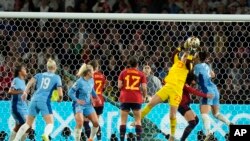 Spain's goalkeeper Cata Coll, second from right, makes a save during the final of Women's World Cup soccer between Spain and England at Stadium Australia in Sydney, Aug. 20, 2023.