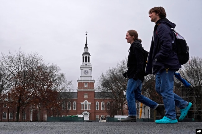 FILE - Students cross the campus of Dartmouth College, on March 5, 2024, in Hanover, N.H. Americans are increasingly skeptical about the value and cost of college. (AP Photo/Robert F. Bukaty, File)