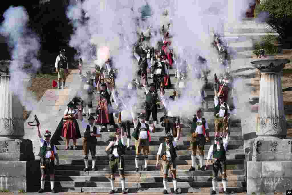 Bavarian riflemen and women in traditional costumes fire their muzzle loaders on the last day of the Oktoberfest beer festival in Munich, Germany.