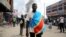 An anti-government demonstrator wears a Democratic Republic of Congo flag as he takes part in a riot in Kinshasa, Democratic Republic of Congo, May 20, 2023.